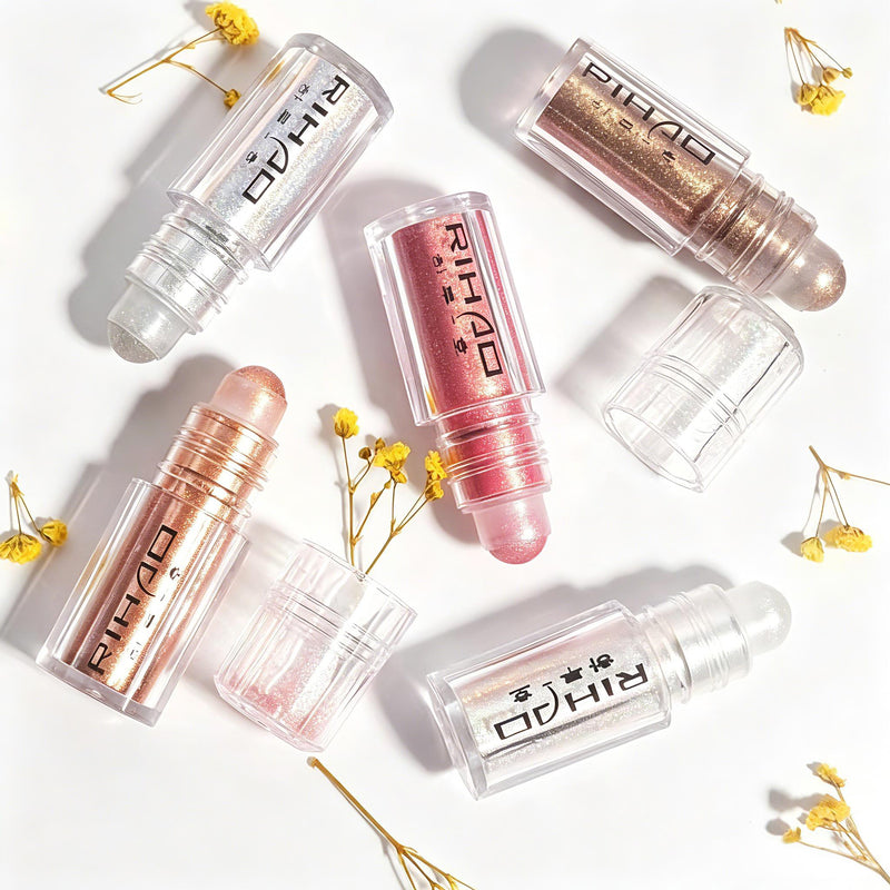 Roll-on liquid highlighter bottles artistic flat lay with dried flowers
